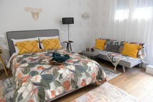 a bedroom with a bed and a couch at Ammos studio Loutraki in Loutraki