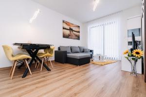 a living room with a table and a couch at Horský apartmán Temari 14 Klínovec in Loučná pod Klínovcem