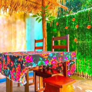 a table with two chairs and a table with a colorful table cloth at Pousada Casa do Ivo Alter do Chão in Alter do Chao
