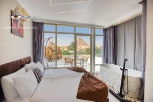 a bedroom with a bed and a view of the pyramids at Shadow Pyramids Palace in Cairo