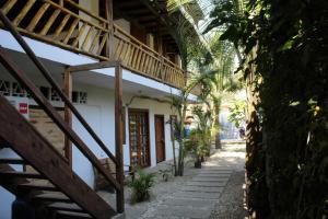 a hallway of a building with stairs and palm trees at Aloha.ayampe in Ayampe