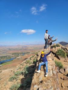 a group of people sitting on top of a mountain at DAR MIMONA 