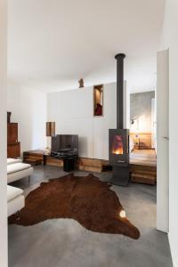 a living room with a fireplace and a couch at @HOME - Mini In Centro Storico in Padova