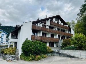 a white building with balconies on the side of it at Charming Apartment in Laax in Laax