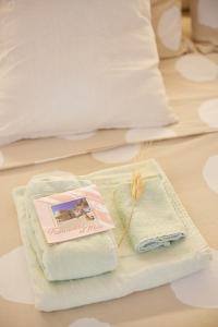 a pair of towels and a book on a bed at Design Sea Apartment -BOHO SUITE- Abruzzo in Francavilla al Mare