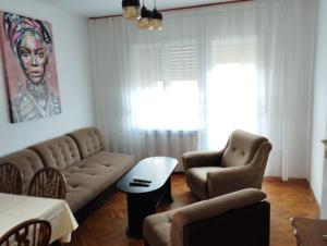 a living room with a couch and two chairs at Vila Mihajlovic in Brus