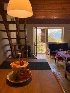 a living room with a table with a bowl of fruit on it at Leunovo Adventure Villa in Leunovo