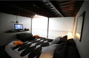 a bedroom with a large bed and a television at Casa Vacanza Saint Patrick DImora del 1200 in Barletta