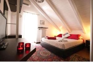 a bedroom with a bed with red pillows at Casa Vacanza Saint Patrick DImora del 1200 in Barletta
