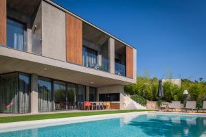 an external view of a house with a swimming pool at ARGENTO RESIDENCE in Zagvozd