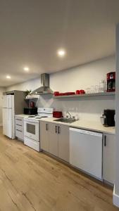 a kitchen with white counters and a white refrigerator at Le Pimbina in Mont-Tremblant
