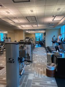 a gym with treadmills and people exercising in the gym at Entire Strip View Suite in Las Vegas