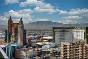 a view of a city with buildings and mountains at Entire Strip View Suite in Las Vegas