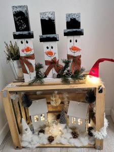 a group of three snowmen decorations on a table at Butterfly Cottage by the Creek in Tržič