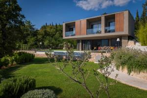 a house with a garden in front of it at ARGENTO RESIDENCE in Zagvozd