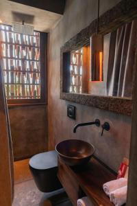 a bathroom with a wooden sink and a mirror at Nomade Holbox in Holbox Island