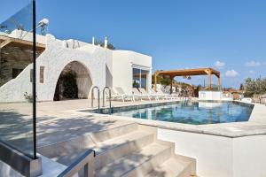 a villa with a swimming pool and a resort at Villa Elena Agia Pelagia - with private swimming pool in Agia Pelagia