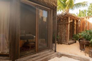 uma vista exterior de uma casa com uma porta de vidro em Nomade Holbox em Holbox