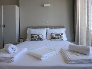 a bedroom with a bed with towels on it at Pantheon Aparthotel in Chania Town