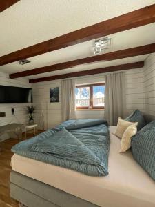 a bedroom with a large bed and a window at Ferienwohnung Jägerheim in Bürserberg