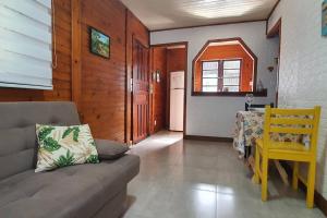 een woonkamer met een bank en een tafel bij Chalé super aconchegante em condomínio com garagem in São Sebastião