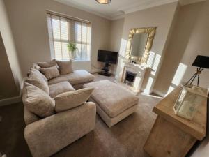a living room with a couch and a fireplace at 2 Victoria Place - Luddendenfoot in Luddenden Foot