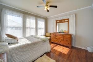 a bedroom with a bed and a dresser and a mirror at Pet-Friendly Brady Vacation Home Near Wineries! in Brady