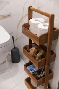 a wooden towel rack in a bathroom with a toilet at Glečer Kop, Cozy design apartment A5 in Kopaonik