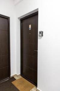 two sets of doors in a room with white walls at Glečer Kop, Cozy design apartment A5 in Kopaonik