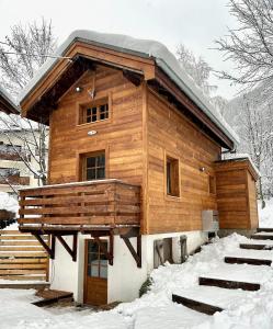 a wooden cabin with snow on the ground at Gorgeous Mini-Chalet Chamonix in Chamonix-Mont-Blanc
