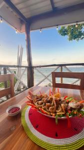 a plate of food on a table with a view of the ocean at Mira Mira Beach in Cartagena de Indias