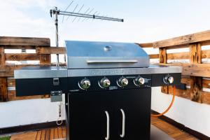 a grill sitting on the deck of a boat at Secret Paradise & SPA Rooftop in Quartu SantʼElena