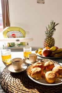 a table with plates of food and cups of coffee at Secret Paradise & SPA Rooftop in Quartu SantʼElena