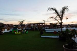 a view of a rooftop patio with grass and plants at Secret Paradise & SPA Rooftop in Quartu SantʼElena +49 photos