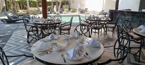 a group of tables and chairs with napkins and dishes at Grand City Hotel Cancun in Cancún
