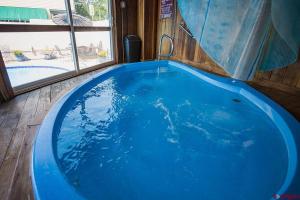 a large blue tub in a room with a window at The Durango Lodge in Durango