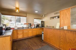a large kitchen with wooden cabinets and a counter at The Durango Lodge in Durango
