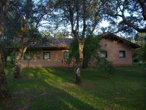 a brick house with trees in front of it at Casa Rural El Roblon in Sartajada