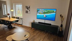 a living room with a flat screen tv on a wall at Ausblick am Wieterturm in Northeim