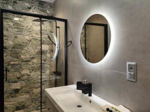 a bathroom with a sink and a mirror at Meteora Scenic Loft in Kalabaka +29 photos