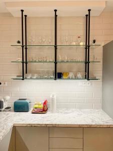 a kitchen with glass shelves and a counter top at Apartment on the Main Street with Parking Old Town in Košice