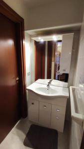 a bathroom with a white sink and a mirror at Casa Aprica piste da sci Baradello in Aprica