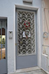 a door with a gate with a flower arrangement on it at Loft at Sokratous in Athens