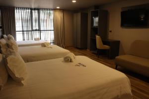 Voodi või voodid majutusasutuse Giluxe Hotel toas
