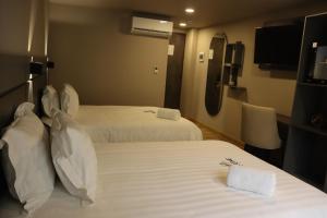 Voodi või voodid majutusasutuse Giluxe Hotel toas