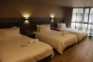 Voodi või voodid majutusasutuse Giluxe Hotel toas