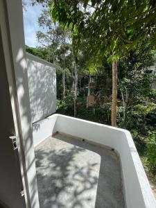 an open door of a house with a concrete wall at Blue River in Santa Marta