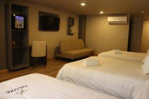 Voodi või voodid majutusasutuse Giluxe Hotel toas