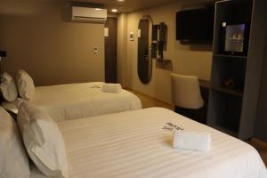 Voodi või voodid majutusasutuse Giluxe Hotel toas