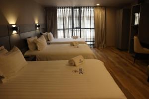 Voodi või voodid majutusasutuse Giluxe Hotel toas